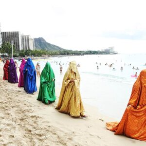 Anida Yoeu Ali, Performance Still, 'The Red Chador: Genesis I', Waikiki Beach, Hawaii, 2019, Image courtesy of the artist